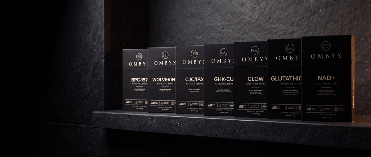 The OMBYX collection of seven dissolvable strips on a dark slate shelf